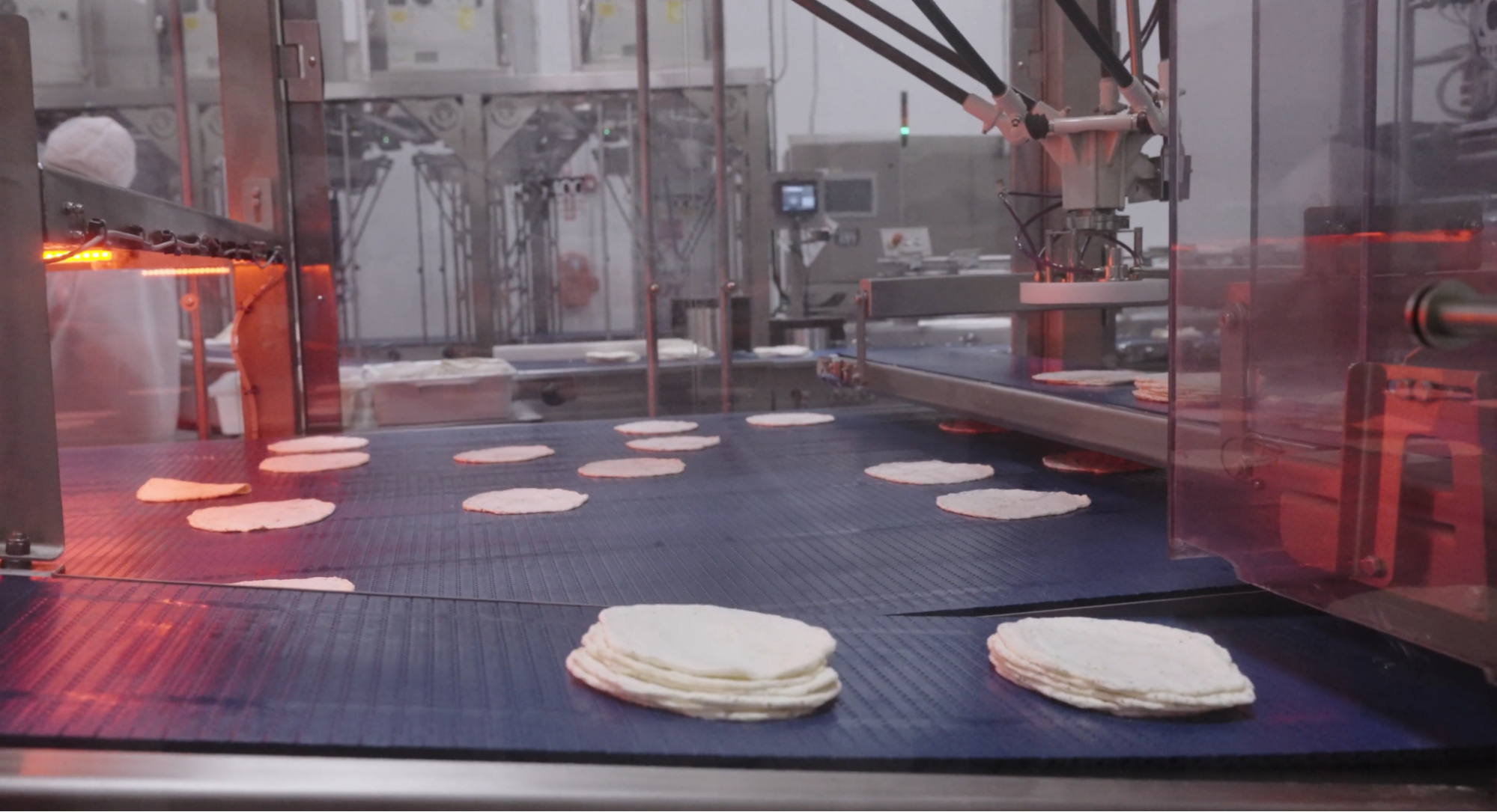 Image of Egglife wraps on a conveyer belt. 